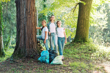 Young women cleaning up the forest