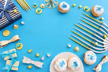Religion image of jewish holiday Hanukkah background with menorah (traditional candelabra), doughnut and candles