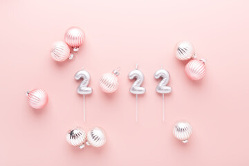 Silver numbers 2022 with balls on pink background. New year celebration. Happy New Year concepts