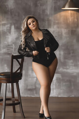 Plus-size woman with long blond hair in a leather jacket, overweight blonde with lush forms in the...