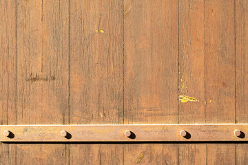 Old wooden door with metal bar
