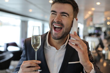 Atractive elegant man making a call from luxurious bar