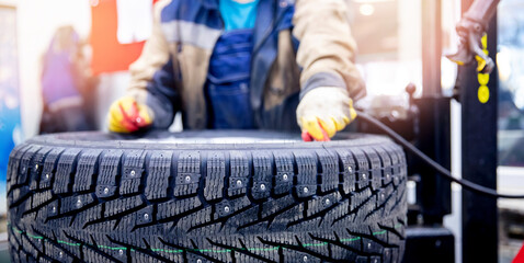 Master mechanic inflates wheel with air at tire fitting station banner photo © Parilov