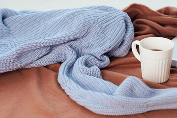 a blanket near the window a cup of coffee book Comfort rest