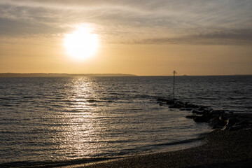 sunset over the sea with The Isle of Wight Hampshire England in the background