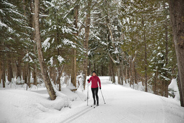 Cross-country skiing Woman in Classic Style Nordic Skiing in winter doing winter sport activity in...