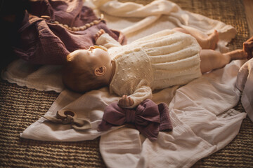 Adorable little newborn baby girl lays in cosy cradle