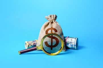 Dollar money bag and magnifying glass. Investigating capital origins. Anti money laundering and tax...
