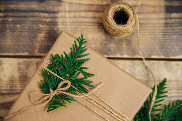 Boxes packed with kraft paper and natural twine on a wooden background.The concept of Christmas and New Year.