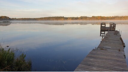 Naklejka na ściany i meble Beautiful Morning at the foggy lake