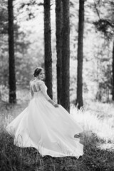 the bride walking in a pine forest