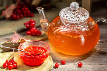 Viburnum jam in a glass bowl on the wooden table