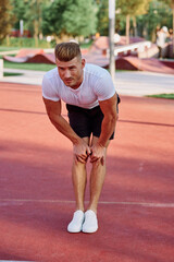 man in white t-shirt on the sports ground workout motivation