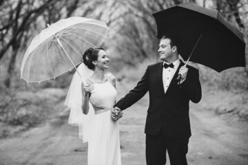 bride and groom on a rainy wedding day walking