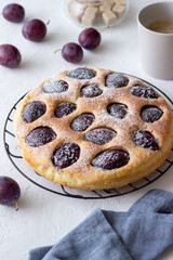 Plum pie on a white background. Baking. Vegetarian food.