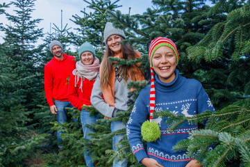 Outdoor Happy Family Choosing Christmas Tree Together