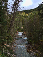 Beautiful portrait view of famous ravine Johnston Canyon in Banff National Park, Alberta, Canada in the Rocky Mountains with stream of clear water.
