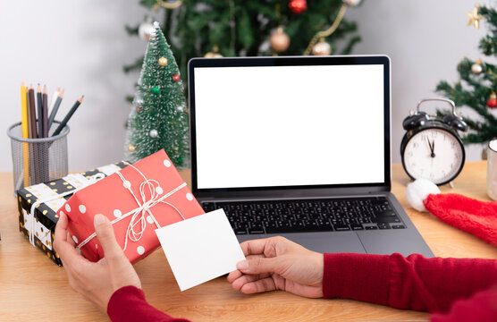 business woman holding giftbox and greeting card on office table in Christmas day.