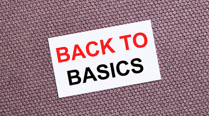 On a brown background, a white rectangular card with the text BACK TO BASICS