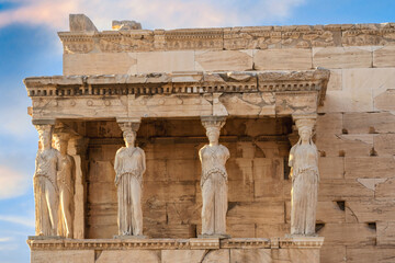 The Caryatids of Erechtheion Temple (Erechtheum) at the archaeological site of Acropolis. Caryatids are sculpted female figures used as decorative architectural support in place of columns or pillars - obrazy, fototapety, plakaty