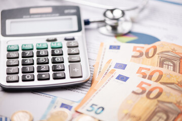 Stethoscope, calculator and euro banknotes .Concept of payment for medical service