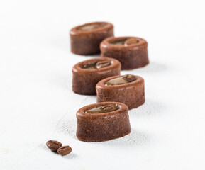 Mini oval coffee muffin in the shape of savarin with filling on a white background