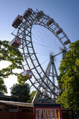 The giant Ferris wheel in Prater, the oldest amusement park in the world, against blue sky, Vienna,...