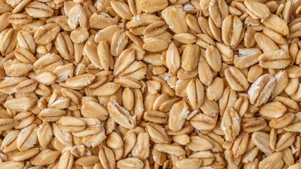 Rolled oat, oat flakes background or texture. Close up, directly above.Heap of dry rolled oats isolated.
