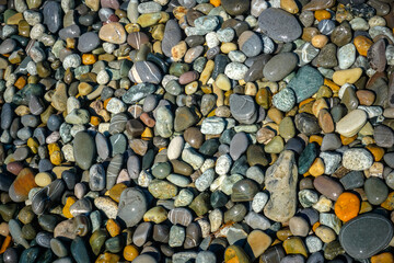 Multi colored pebbles on the beach