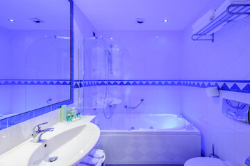 Fragment of a luxury bathroom in blue light.