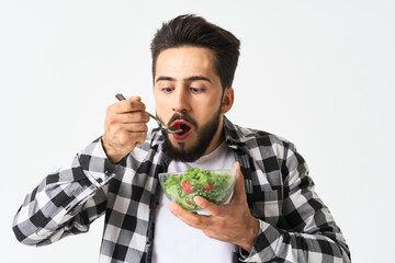 man in plaid shirt eating salad healthy food