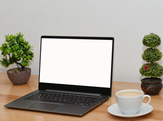 Mockup image of laptop with blank white screen on wooden table in modern space 