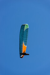 Paragliding Pilot Flying a Paraglider - 468448204