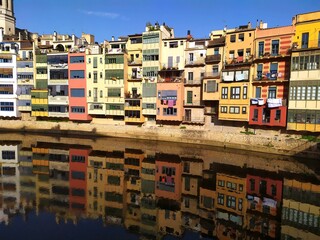 Colored houses reflected in the river