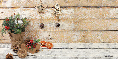 Empty rustic table with live Christmas tree in eco bag and homemade gift boxes and...