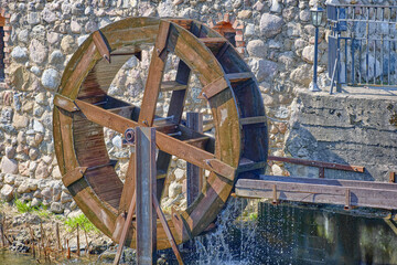 The water flow driving the water mill wheel