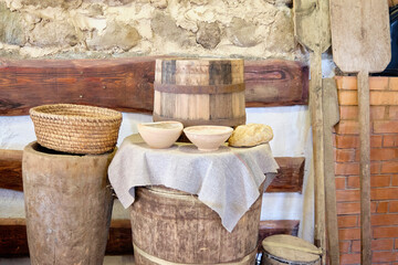 bowls of flour and bread on a wooden barrel in the old days
