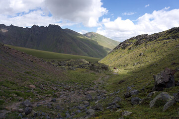 summer mountain landscape. Caucasus mountains, Elbrus region. sunbeams and beautiful, expressive cloudy sky