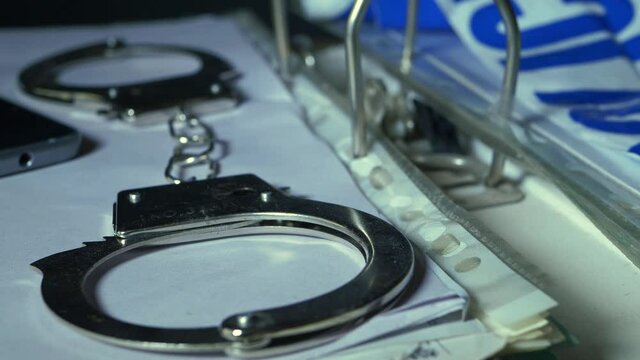 Handcuffs and documents in a police criminal investigation