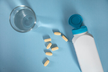drugs and bottle with glass of water