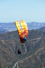 Paragliding Pilot Flying a Paraglider - 468452402