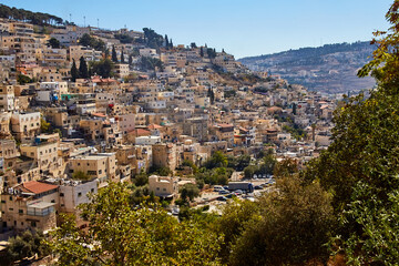 Fototapeta na wymiar view from city of David on Silwan or Siloam is arab neighborhood in East Jerusalem, on outskirts of Old City of Jerusalem, Israel