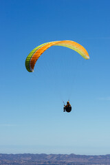 Paragliding Pilot Flying a Paraglider - 468452416