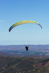Paragliding Pilot Flying a Paraglider - 468452643