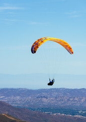 Paragliding Pilot Flying a Paraglider - 468452689