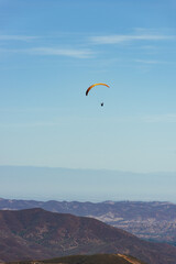 Paragliding Pilot Flying a Paraglider - 468452692