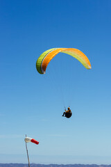 Paragliding Pilot Flying a Paraglider - 468452813