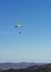 Fototapeta na wymiar Paragliding Pilot Flying a Paraglider