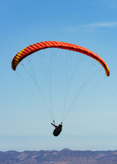 Paragliding Pilot Flying a Paraglider - 468452869