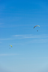 Paragliding Pilot Flying a Paraglider - 468452880